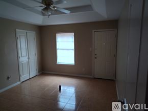 Edinburg apartment for rent - A room with a ceiling fan and a window.