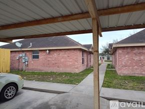 Edinburg apartment for rent - A car is parked under a covered walkway.