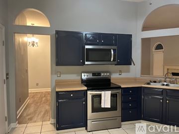 Mount Pleasant house for rent - A kitchen with dark cabinets and stainless steel appliances.
