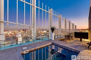 Las Vegas apartment for rent - A pool on a balcony with a view of the city at dusk.