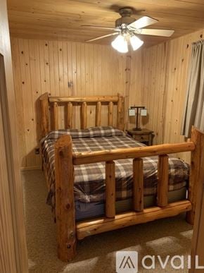 Long Prairie house for rent - A bedroom with a bed and a ceiling fan.