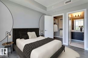Edmonton townhouse for rent - A modern kitchen with a marble countertop and stainless steel appliances.