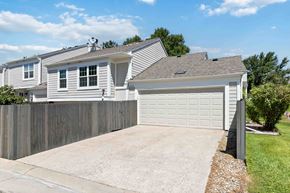 Parker house for rent - A house with a grey garage door and a grey fence.