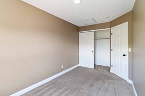 Parker house for rent - A room with a carpeted floor and two white doors.