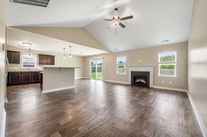 Hubert house for rent - A spacious living room with wood flooring and a ceiling fan.