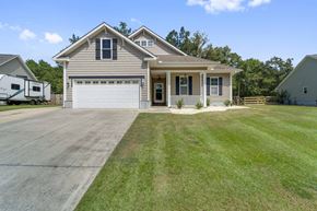 Jacksonville house for rent - A house with a garage and a driveway in front of it.