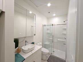 Winnipeg apartment for rent - A white bathroom with a sink, toilet, and shower.