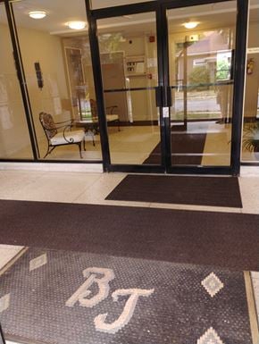 Belleville apartment for rent - A glass door with a mat in front of it that says BT.