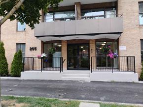 Belleville apartment for rent - A building with a balcony and a sign that reads "245" on the front door.