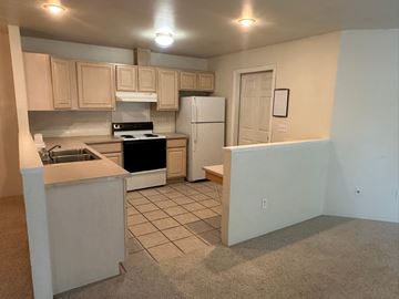Grandview apartment for rent - A kitchen with a white refrigerator and a white stove.
