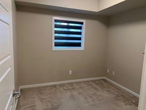 Edmonton house for rent - A room with a window and carpeted floor.