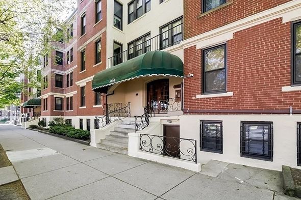 Boston apartment for rent - A row of red brick buildings with a green awning on the first one.