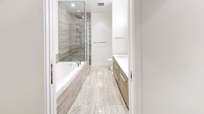 Richmond apartment for rent - A bathroom with a walk-in shower and a white wall.