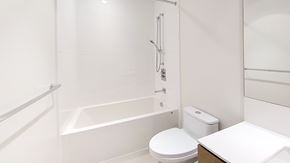 Richmond apartment for rent - A white bathroom with a toilet, sink, and bathtub.