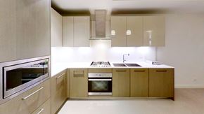 Richmond apartment for rent - A modern kitchen with wooden cabinets and stainless steel appliances.