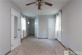 Fairfield house for rent - A spacious room with a ceiling fan and carpeted floor.