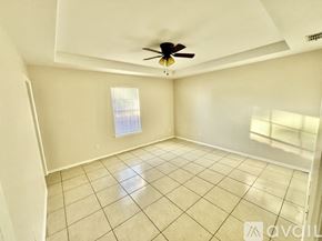 Mc Allen apartment for rent - A room with a ceiling fan and tiled floor.