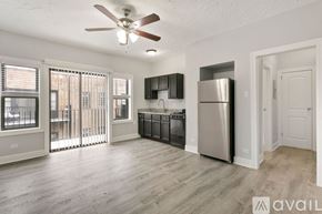 Chicago apartment for rent - A modern kitchen with stainless steel appliances and a ceiling fan.