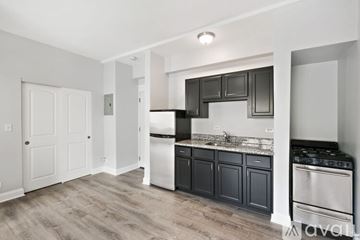 Chicago apartment for rent - A kitchen with black cabinets and stainless steel appliances.