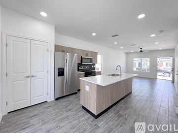 Edinburg house for rent - A modern kitchen with a central island and a refrigerator.