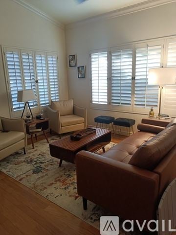 Surprise house for rent - A living room with a brown leather couch and a rug.