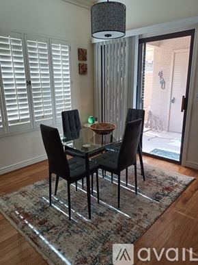 Surprise house for rent - A dining room with a table and four chairs.