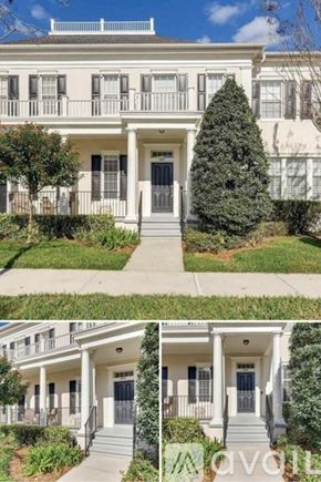 Orlando townhouse for rent - A white two-story house with a front porch and a tree in front.