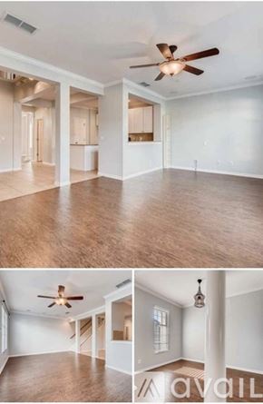 Orlando townhouse for rent - A living room with a ceiling fan and a kitchen area in the background.