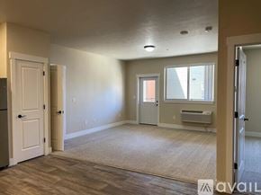 Missoula apartment for rent - A spacious room with a door on the left and a window on the right.