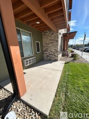 Missoula apartment for rent - A building with a green wall and a brown roof.
