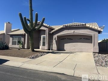 Tucson house for rent - A kitchen with a table and chairs in the middle of the room.