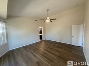 Tucson house for rent - A bathroom with a glass shower stall and a white bathtub.