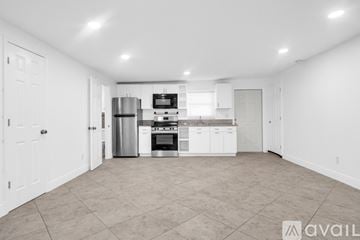 Fort Lauderdale apartment for rent - A spacious kitchen with white cabinets and appliances.
