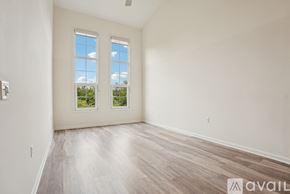 Eastampton Township apartment for rent - A spacious room with two windows and wooden flooring.