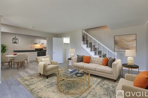 Nashville townhouse for rent - A spacious living room with a staircase leading to the upper floor.