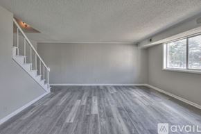 Nashville townhouse for rent - A spacious room with wooden flooring and a staircase.