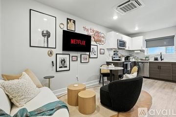 Dallas apartment for rent - A living room with a white couch and a black chair.