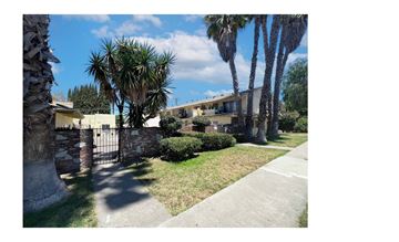 Anaheim apartment for rent - A sunny day in front of a house with a palm tree.