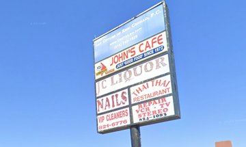 Dallas apartment for rent - A sign for John's Cafe advertises nail salon and Thai restaurant services.