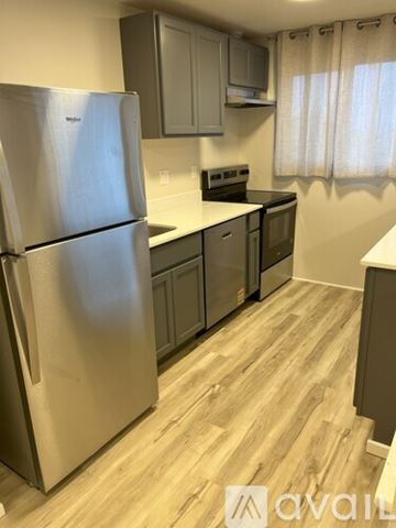 Bremerton apartment for rent - A kitchen with a stainless steel refrigerator and wooden flooring.
