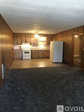 Dickson apartment for rent - A kitchen with wooden walls and a white fridge.