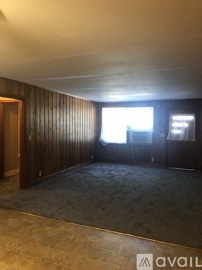 Dickson apartment for rent - A room with wooden walls and a carpeted floor.