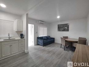 Miami apartment for rent - A living room with a couch, table, and chairs.