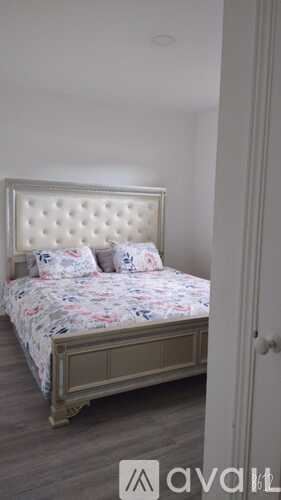 Miami apartment for rent - A bed with a floral bedspread and pillows is in the image.