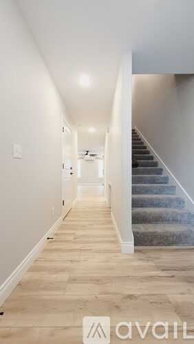 Joplin townhouse for rent - A pool surrounded by a wooden fence with trees in the background.