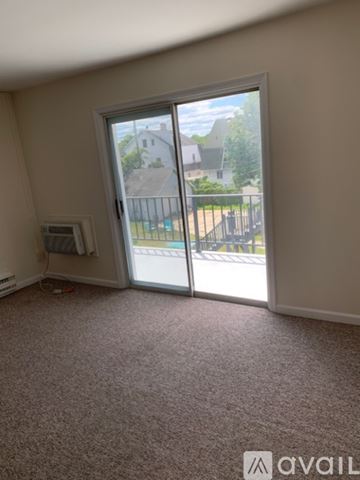 Asbury Park apartment for rent - A kitchen with a white stove and wooden cabinets.