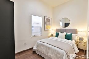 Oakland house for rent - A bedroom with a large bed and a mirror above it.
