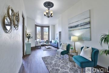 Oakland house for rent - A living room with a blue chair and a painting on the wall.