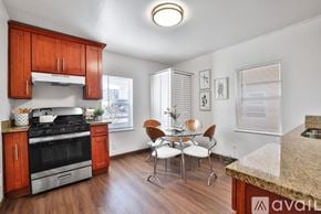 Oakland house for rent - A kitchen with wooden cabinets and a granite countertop.