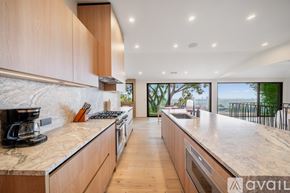 Los Angeles house for rent - A kitchen with wooden cabinets and a marble countertop.